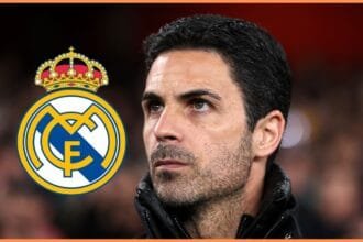 Mikel Arteta looks at Real Madrid club badge.