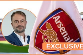 Christian Falk looks on next to Arsenal corner flag.