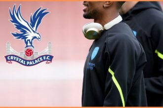 Reiss Nelson of Arsenal and the Crystal Palace logo