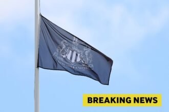 A Newcastle United flag and breaking news banner