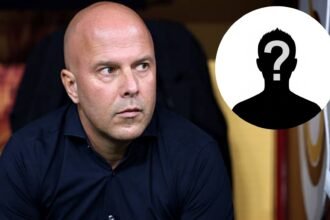 Arne Slot sits down in the dugout during Liverpool