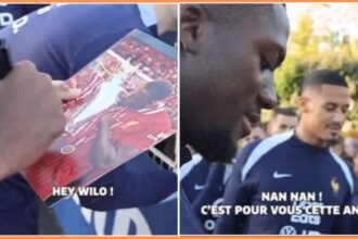 Ibrahima Konate signing an autograph