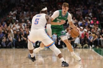 Cooper Flagg No. 32 of the Dallas Mavericks is defended by No. 5 Luguentz Dort of the Oklahoma City Thunder during the second half at American Airlines Center on October 27, 2025 in Dallas, Texas.