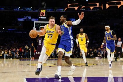 Los Angeles Lakers' No. 77 Luka Doncic drives the ball against Golden State Warriors' No. 1 Jonathan Kuminga.