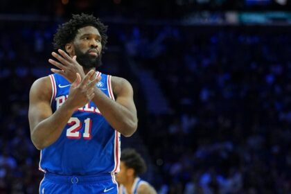 Joel Embiid #21 of the Philadelphia 76ers reacts after making a basket against the Charlotte Hornets.