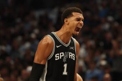 Victor Wembaneyama #1 of the San Antonio Spurs reacts to his first half score against the Dallas Mavericks at American Airlines Center.