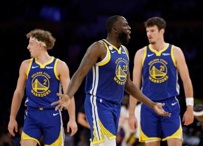 Draymond Green #23 of the Golden State Warriors reacts to an offensive foul in front of Brandin Podzemski #2 and Quinten Post #21 during the Warriors' 119-109 win in the season opener between the Golden State Warriors and the Los Angeles Lakers on October 21, 2025 at Crypto.com Arena in Los Angeles, California.