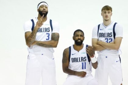 Dallas Mavericks players Anthony Davis #3, Kyrie Irving #11, and Cooper Flagg #32 pose for a photo during Dallas Mavericks Media Day at American Airlines Center.