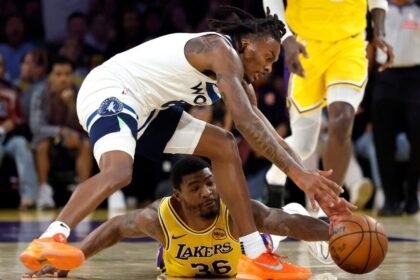 Marcus Smart #36 of the Los Angeles Lakers dives for the ball against Bones Hyland #8 of the Minnesota Timberwolves during the first half at Crypto.com Arena.