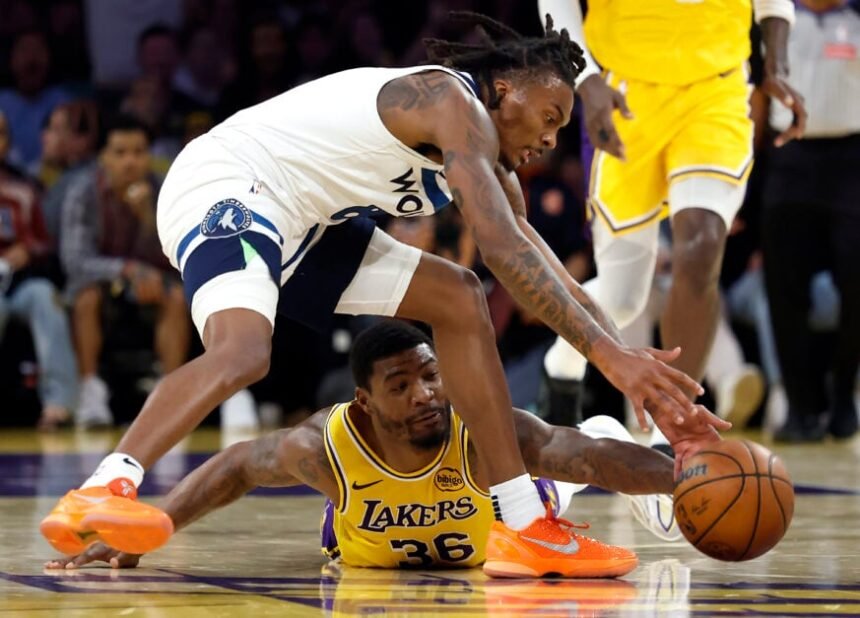 Marcus Smart #36 of the Los Angeles Lakers dives for the ball against Bones Hyland #8 of the Minnesota Timberwolves during the first half at Crypto.com Arena.