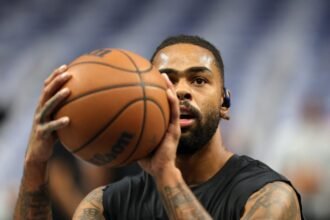 D'Angelo Russell #5 of the Dallas Mavericks participates in pregame warmups against the San Antonio Spurs at American Airlines Center.