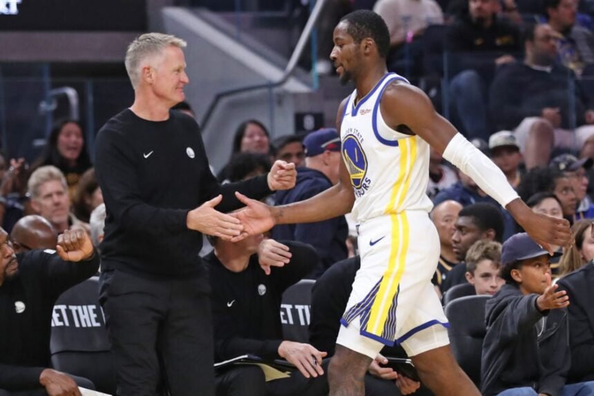 Golden State Warriors head coach Steve Kerr claps hands with Jonathan Kuminga