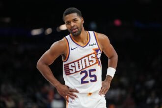 Jared Butler #25 of the Phoenix Suns watches the second half of a preseason NBA game against the Los Angeles Lakers at Mortgage Matchup Center on October 14, 2025 in Phoenix, Arizona.