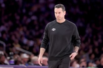 Los Angeles Lakers head coach JJ Redick walks during the NBA playoffs against the Minnesota Timberwolves.