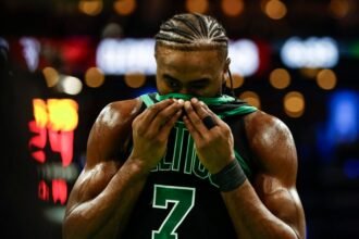 #7 Jaylen Brown of the Boston Celtics watches the game against the Cleveland Cavaliers during the third quarter of the Emirates NBA Cup at TD Garden.