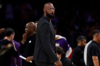 #23 LeBron James of the Los Angeles Lakers watches the third quarter of the game against the Golden State Warriors at Crypto.com Arena.