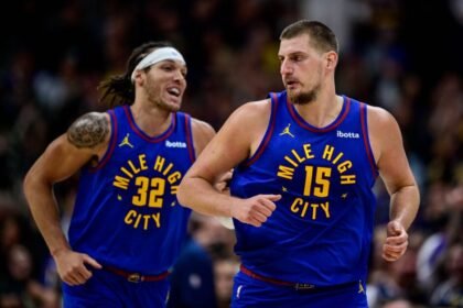 Nikola Jokic #15 and Aaron Gordon #32 of the Denver Nuggets celebrate hitting shots in the second half of the game against the Utah Jazz at Ball Arena.
