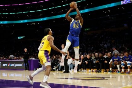 Jimmy Butler III #10 of the Golden State Warriors takes a jumper against Gabe Vincent #7 of the Los Angeles Lakers during the third quarter of a game at Crypto.com Arena.