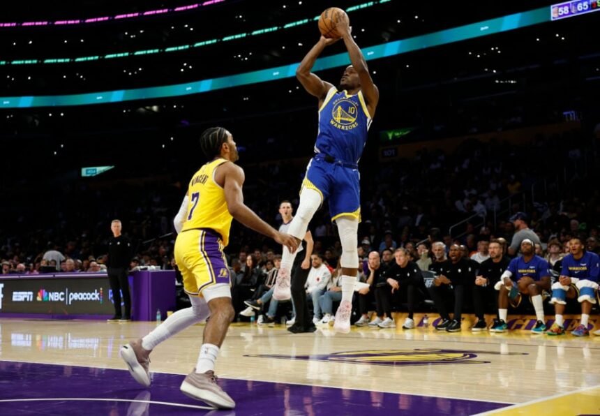 Jimmy Butler III #10 of the Golden State Warriors takes a jumper against Gabe Vincent #7 of the Los Angeles Lakers during the third quarter of a game at Crypto.com Arena.