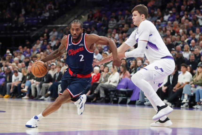 Kawhi Leonard #2 of the Los Angeles Clippers dribbles the ball around #24 Walker Kessler of the Utah Jazz during the first half of a game at Delta Center on October 22, 2025 in Salt Lake City, Utah.