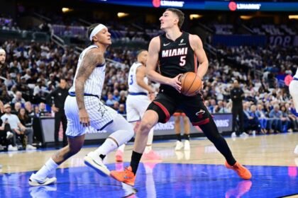 Miami Heat forward Nikola Jovic attempts a shot against Orlando Magic forward Paolo Banchero.