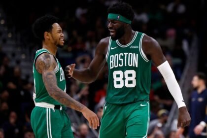 #88 Niemias Queta and #4 Anfernee Simons of the Boston Celtics react after making 3-point baskets during the fourth quarter of the NBA game against the New Orleans Pelicans at Smoothie King Center.
