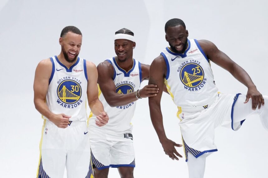 Jimmy Butler III #10, Stephen Curry #30, and Draymond Green #23 of the Golden State Warriors joke during Golden State Warriors media day at Chase Center.