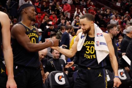Jimmy Butler #10 and Stephen Curry #30 of the Golden State Warriors celebrate