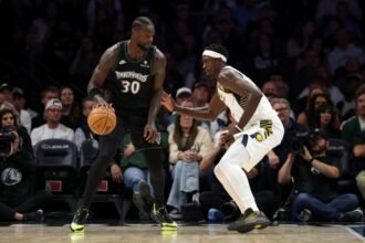 Julius Randle #30 of the Minnesota Timberwolves dribbles the ball against Pascal Siakam #43 of the Indiana Pacers.