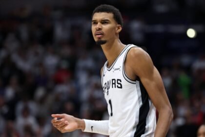 Victor Wembaneyama #1 of the San Antonio Spurs watches the game against the New Orleans Pelicans at the Smoothie King Center.