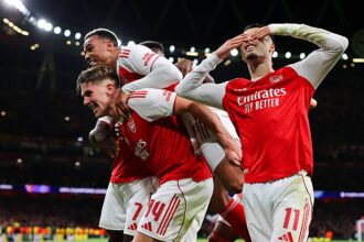 Arsenal players celebrate after scoring against Atletico Madrid