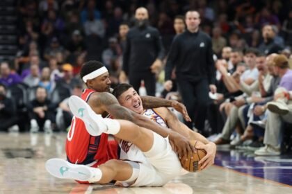 Phoenix Suns #8 Grayson Allen and Los Angeles Clippers #0 Bradley Beal compete for a loose ball.