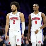 Cade Cunningham #2 and Orser Thompson #9 of the Detroit Pistons watch the second half of the game against the Philadelphia 76ers at Xfinity Mobile Arena.
