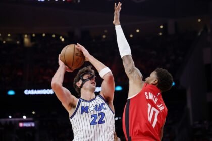 Orlando Magic No. 22 Franz Wagner shoots the ball against Jabari Smith Jr. of the Houston Rockets during the first half at Toyota Center on November 16, 2025 in Houston, Texas.