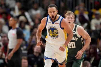 #30 Stephen Curry of the Golden State Warriors reacts after making a 3-point shot during the third quarter against the Milwaukee Bucks at Fiserv Forum.