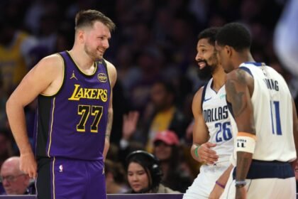 Luka Doncic #77 of the Los Angeles Lakers laughs with Kyrie Irving #11 and Spencer Dinwiddie #26 of the Dallas Mavericks during the first half of a game at Crypto.com Arena on February 25, 2025.
