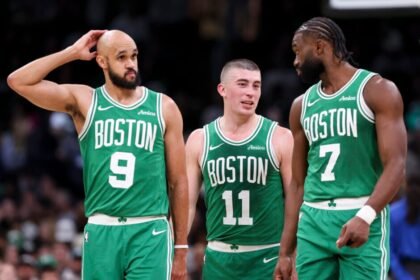 Derrick White #9 of the Boston Celtics, Payton Pritchard #11 of the Boston Celtics and Jaylen Brown #7 of the Boston Celtics react during the game against the Detroit Pistons.