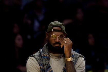 Los Angeles Lakers forward LeBron James, 23, sits on the bench during the first half of an NBA basketball game against the Miami Heat at Crypto.com Arena.