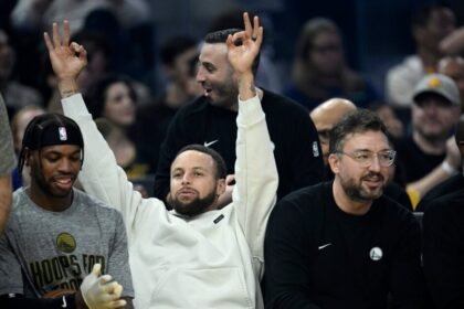Golden State Warriors superstar Stephen Curry celebrates his team's 3-point shot on the sideline.